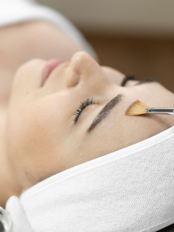 Woman getting a chemical peel in a spa.