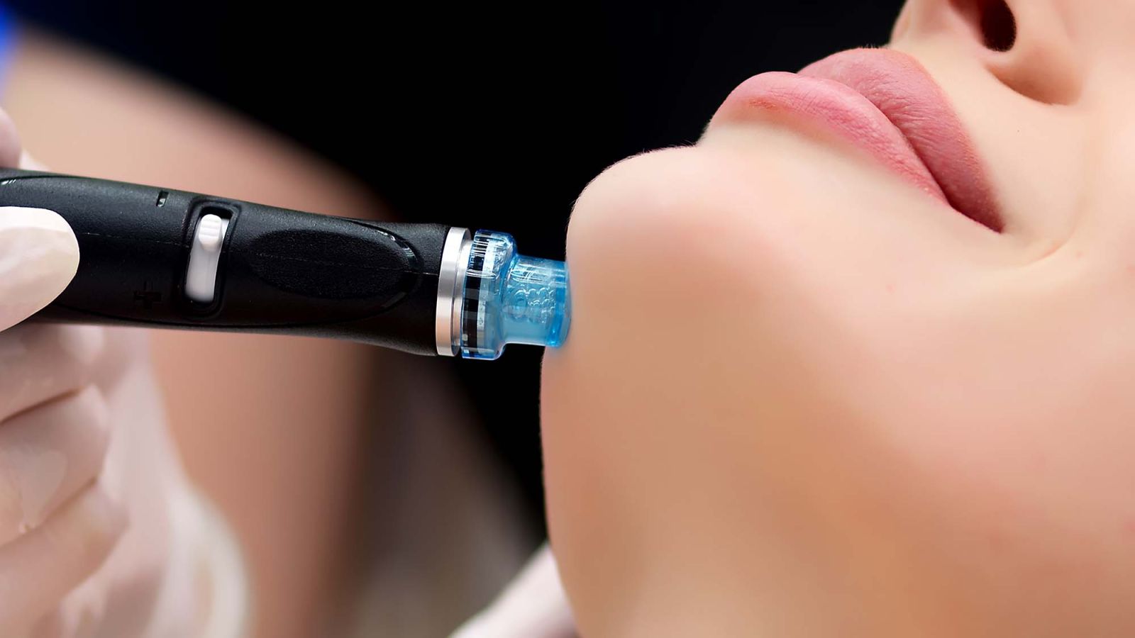 A hydrafacial hand piece used in a facial treatment.