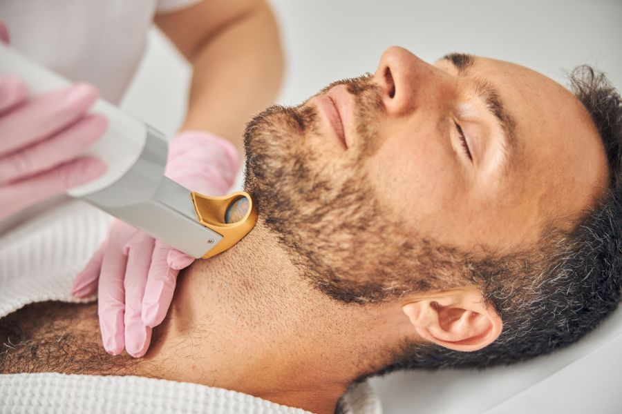 Handsome bearded man having laser hair removal procedure
